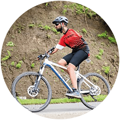 Customer Service Associate riding a mountain bike with one hand